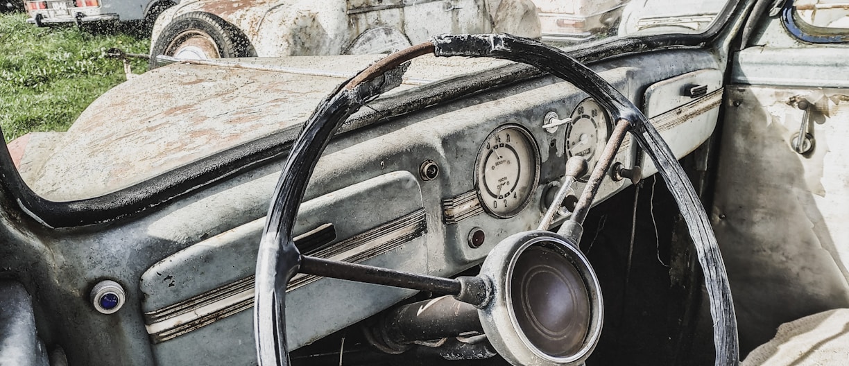 an old car with a steering wheel and dashboard