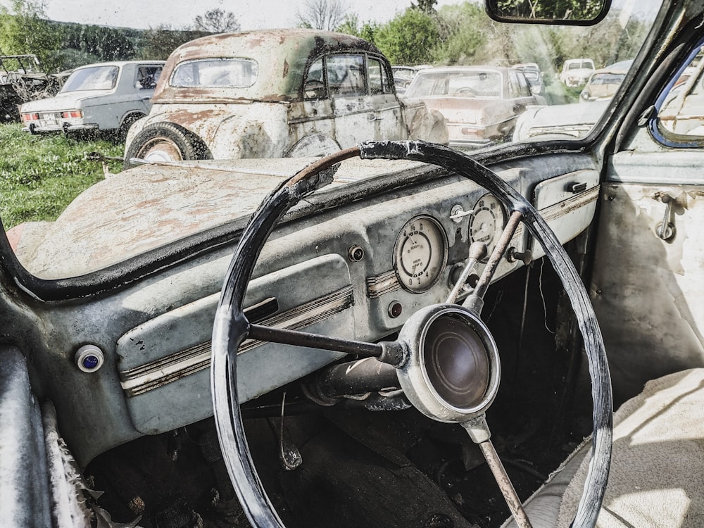 an old car with a steering wheel and dashboard