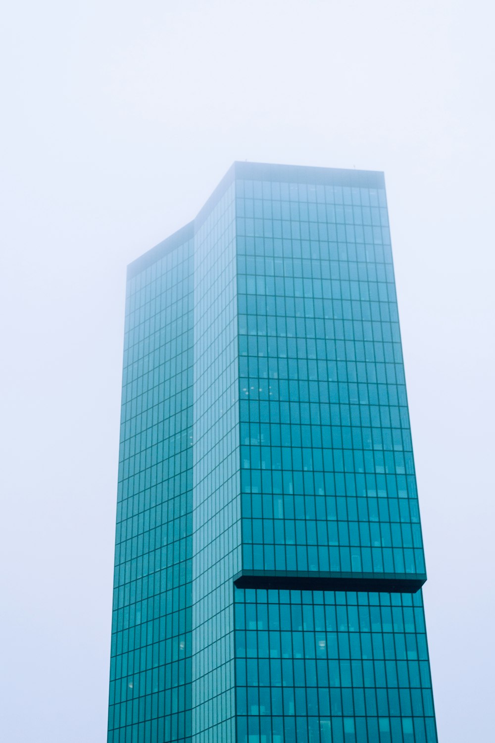 blue glass walled high rise building