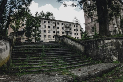 gray concrete building near green trees during daytime