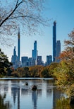 body of water near trees and high rise buildings during daytime
