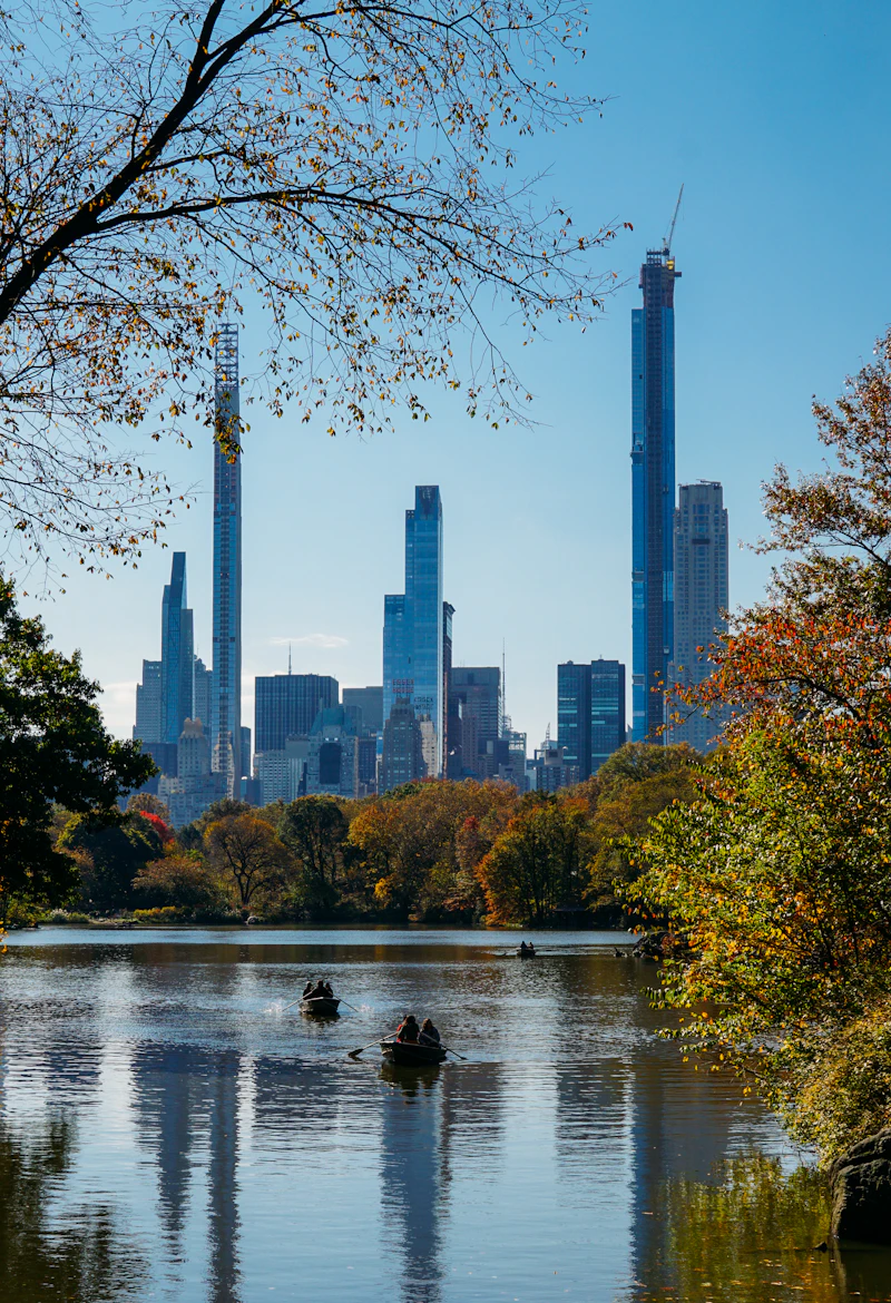 Autumn trees and Manhattan buildings beside the water in Central Park