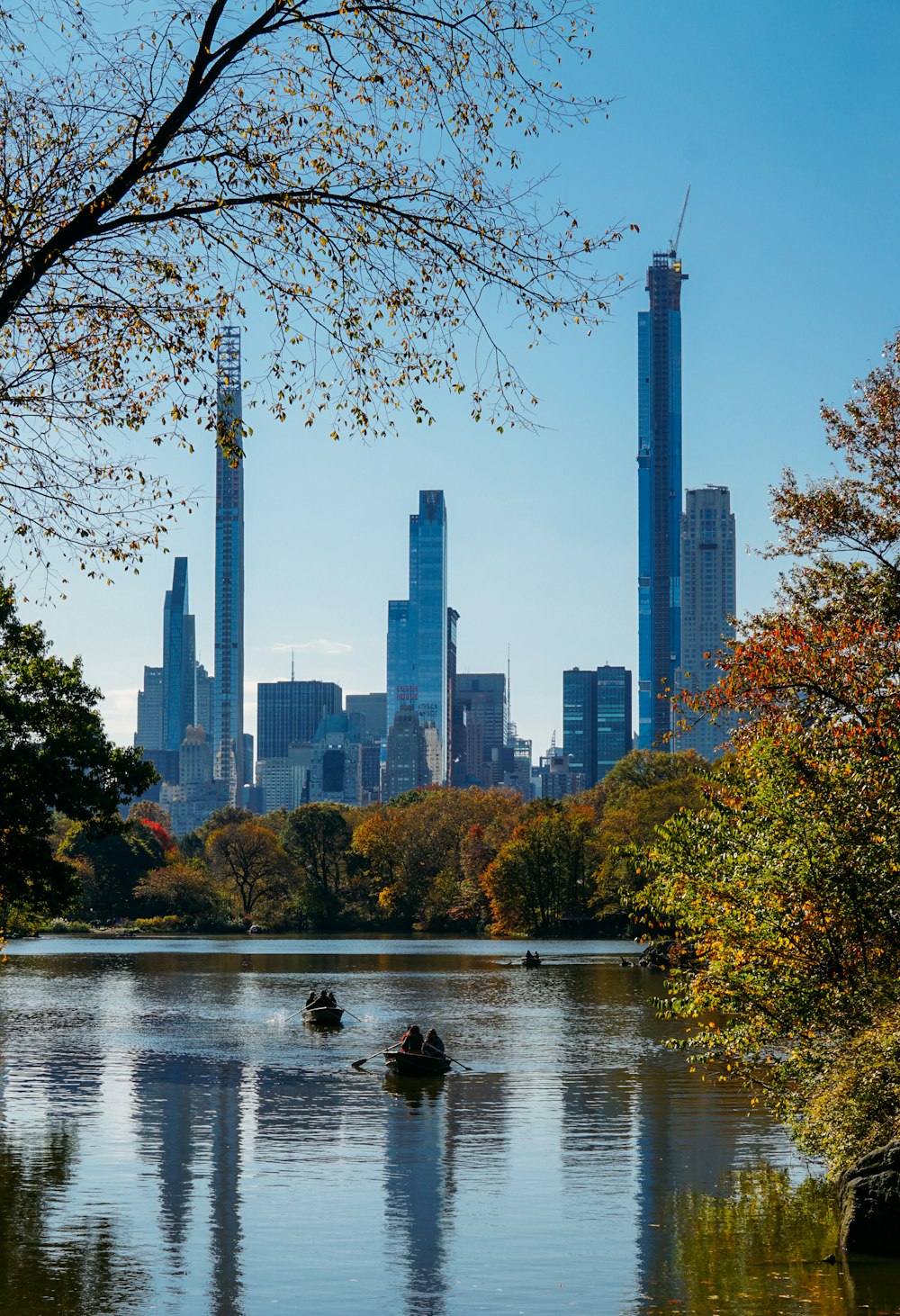 body of water near trees and high rise buildings during daytime