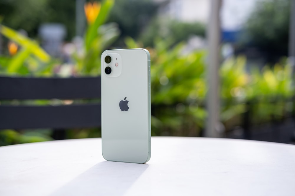 white iphone 5 c on white table