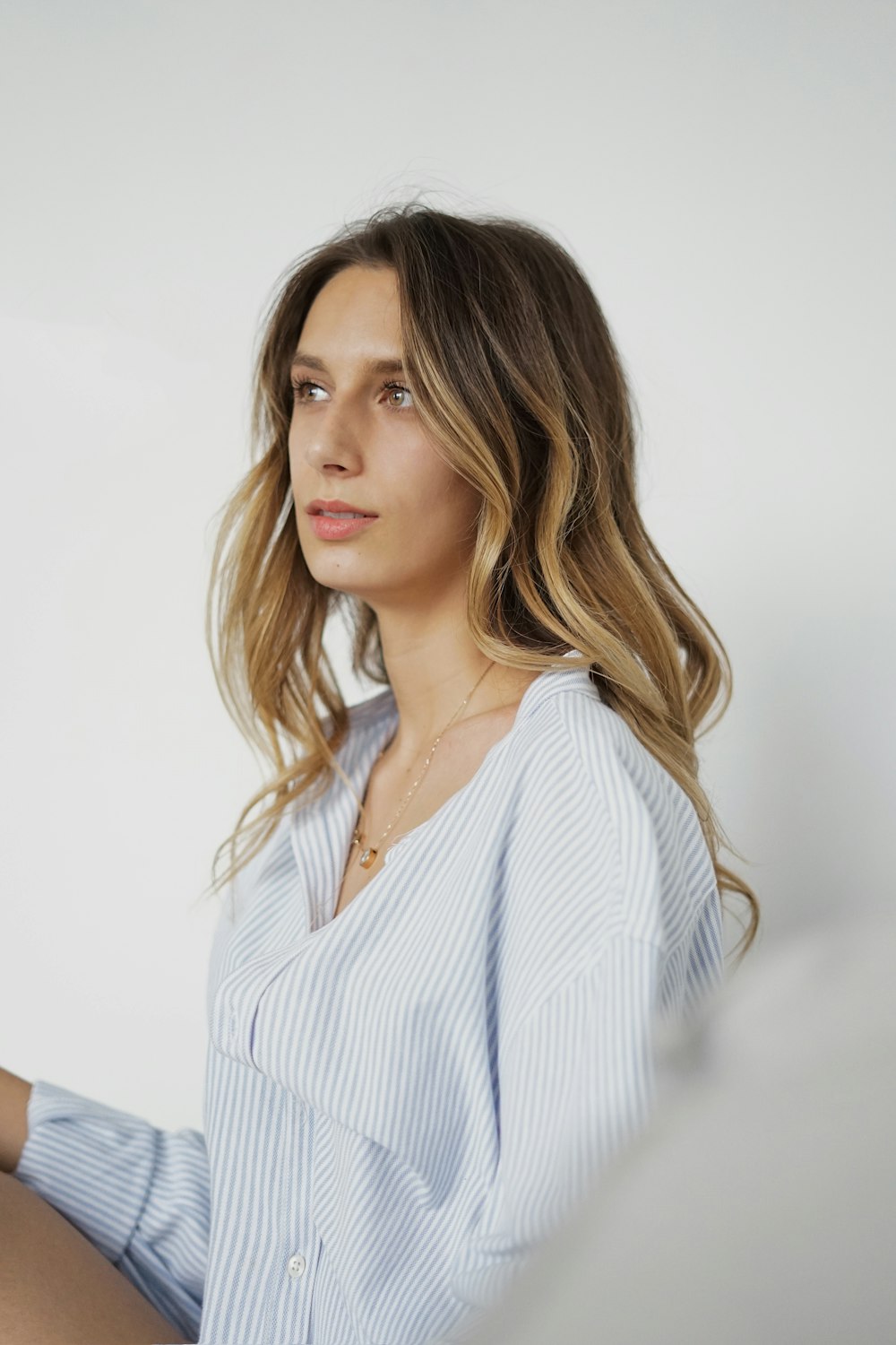 woman in white and blue striped dress shirt