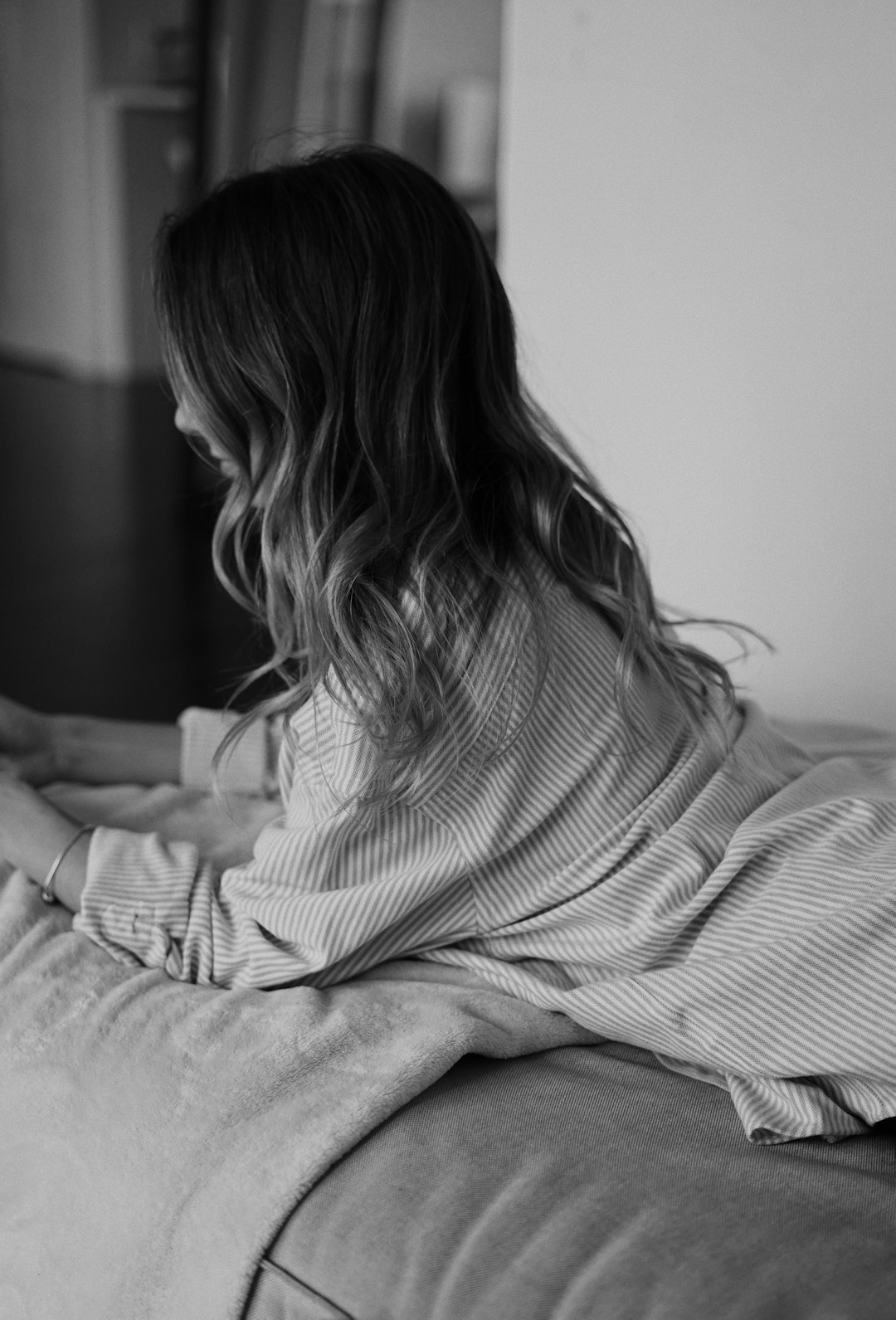 grayscale photo of woman in stripe shirt