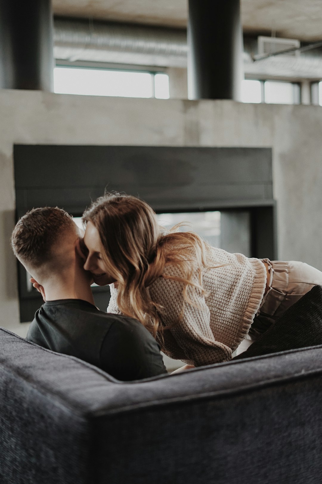 man and woman kissing on the window