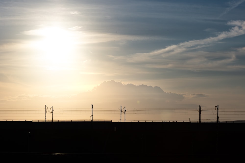 silhouette of people walking on beach during sunset