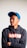 man in black and orange pullover hoodie wearing blue cap