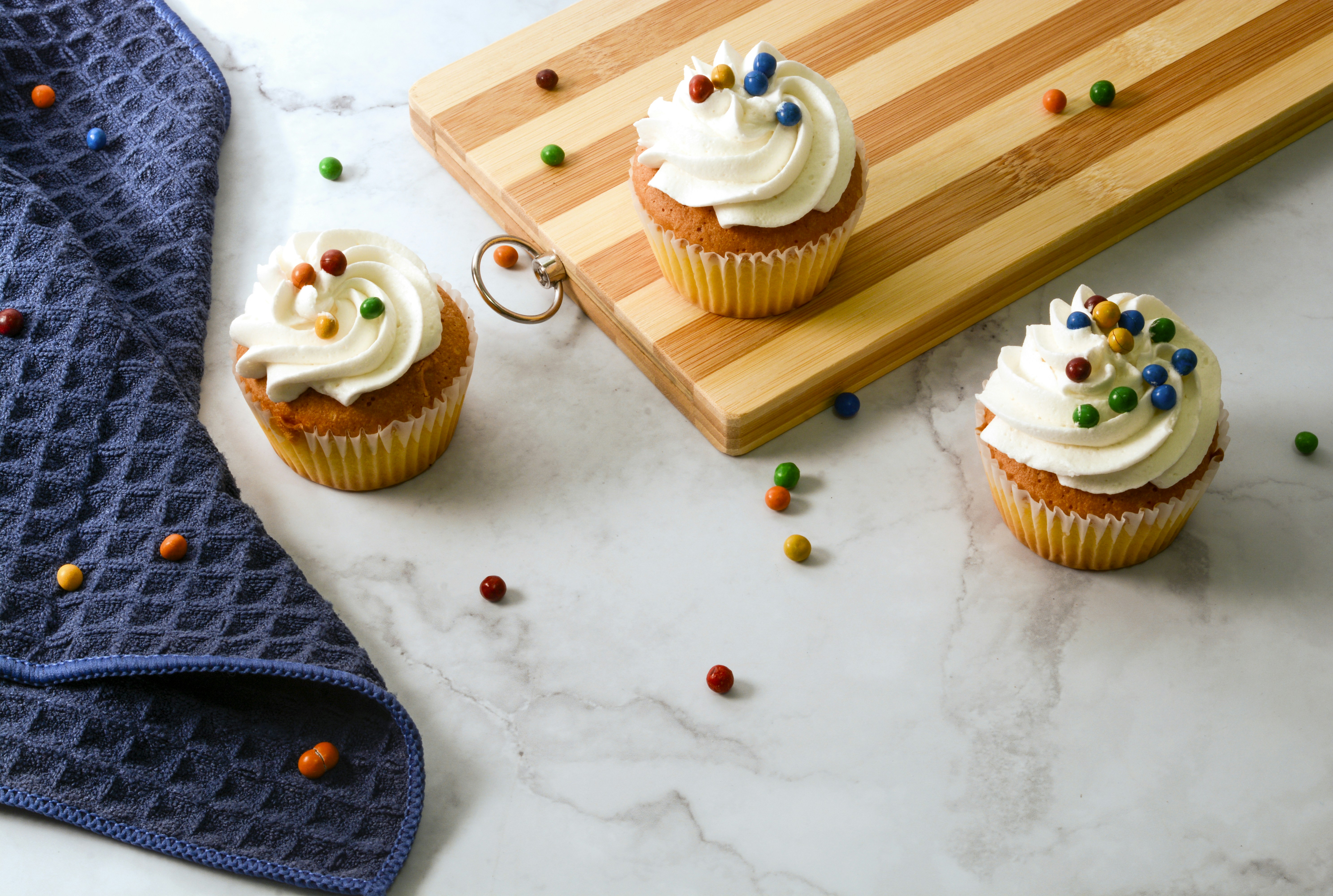 cupcake with white icing on white table