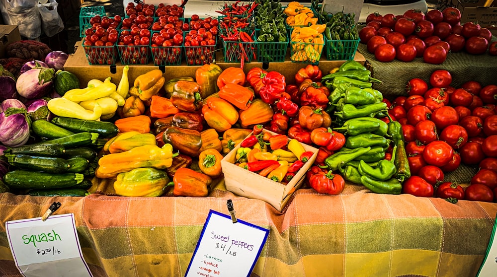 table full of colourful vegetables including peppers, squash, tomatoes. Shop local Winnipeg Metropolitan Region.