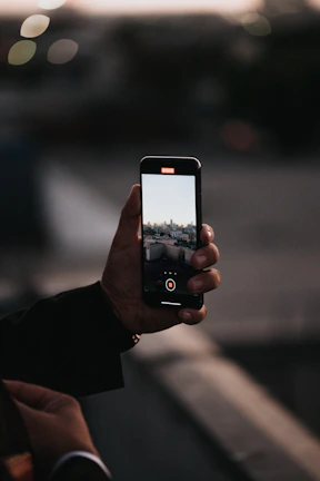 person holding black iphone 4