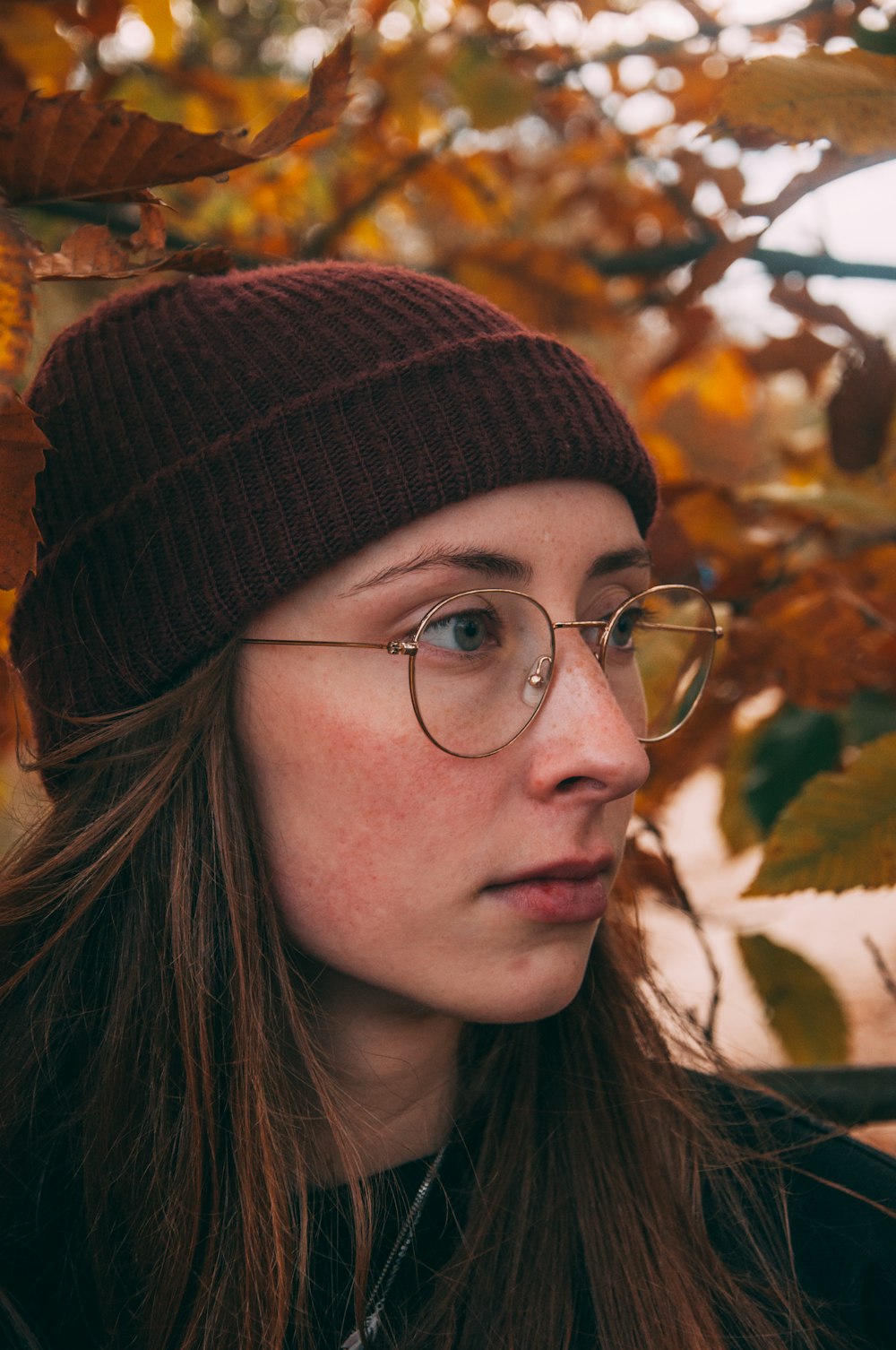 woman wearing black knit cap and black framed eyeglasses