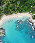 an aerial view of a sandy beach and blue water