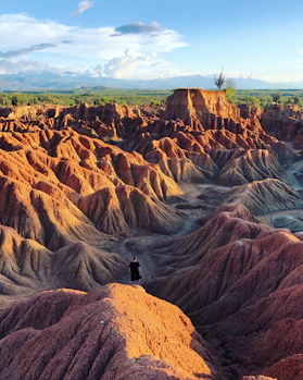 a person standing on top of a large hill