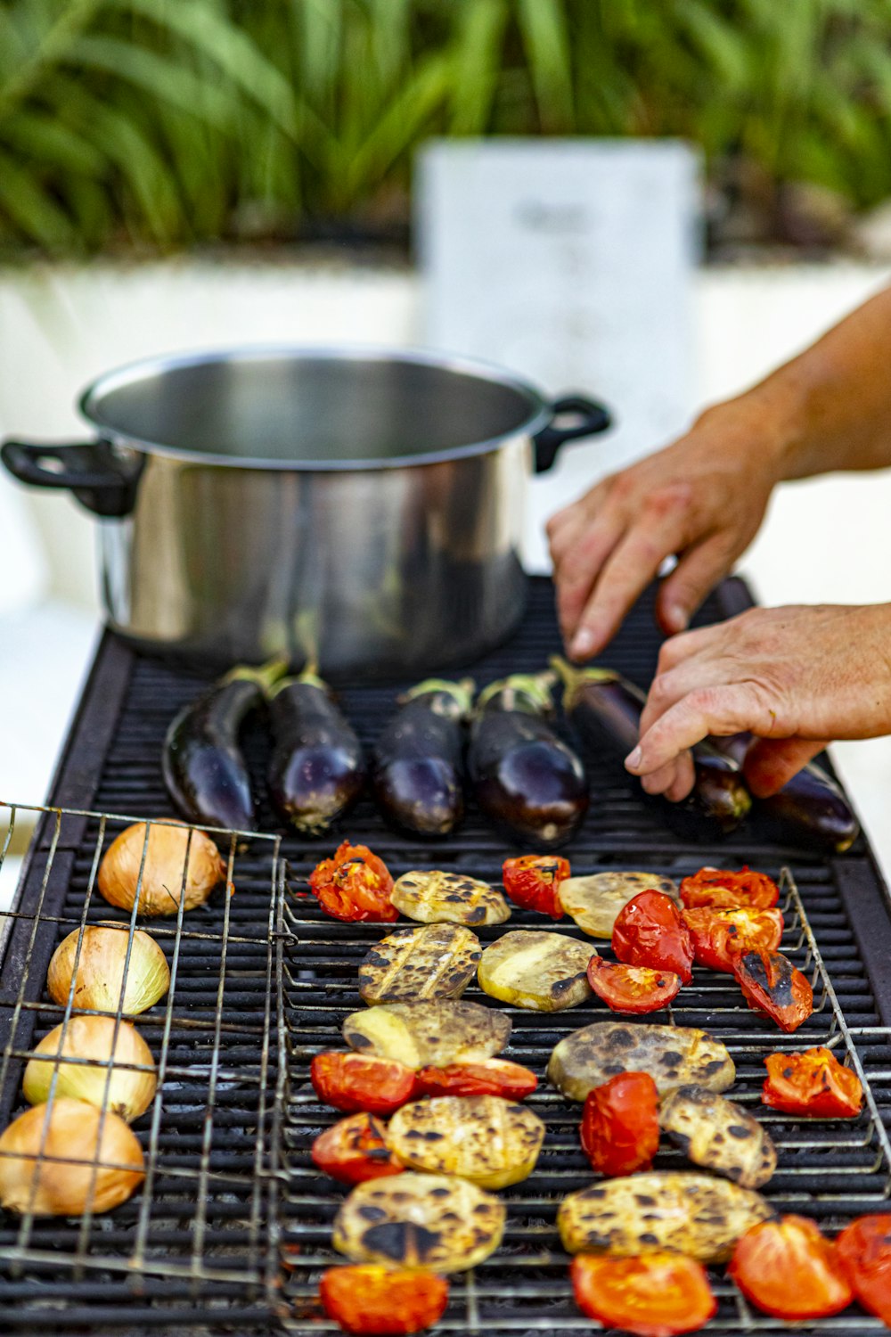 person cooking meat on black grill