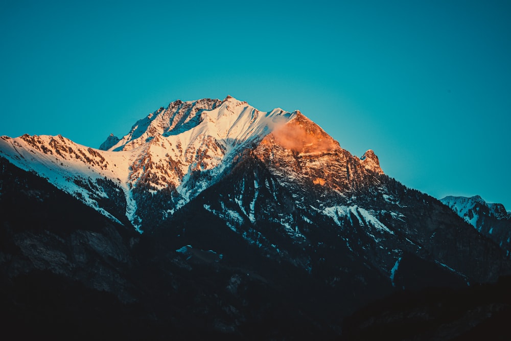 snow covered mountain under blue sky during daytime