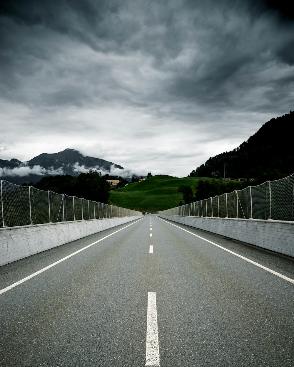 gray concrete road under gray sky