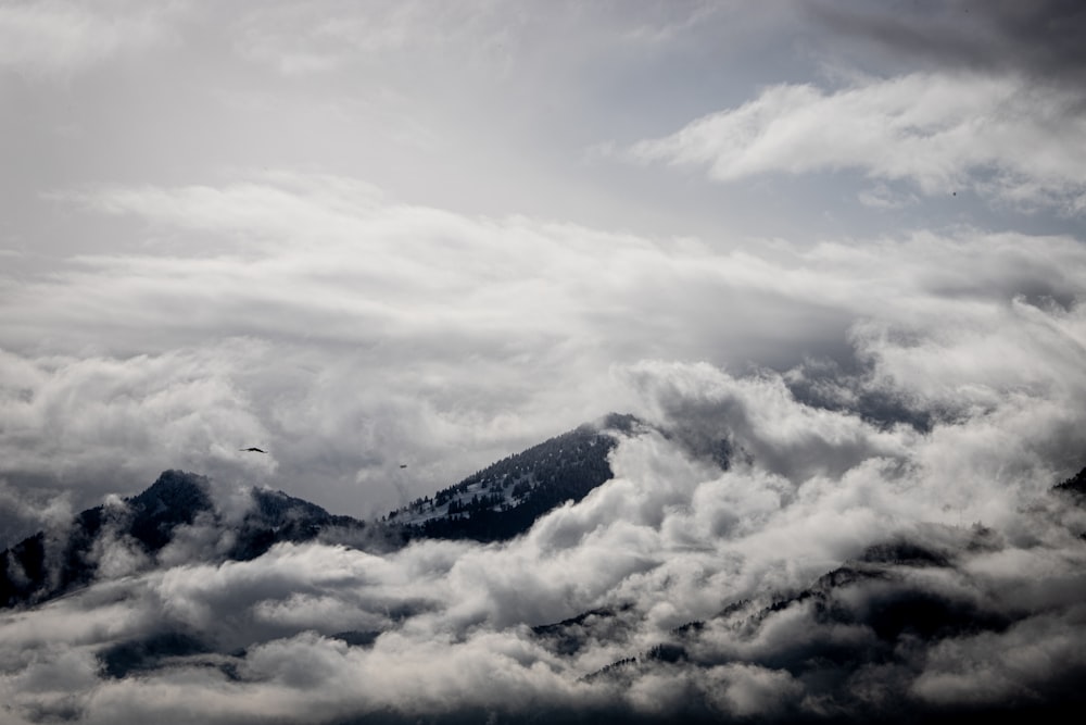 white clouds over mountains during daytime