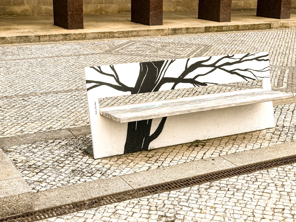 white and black bench on gray concrete floor