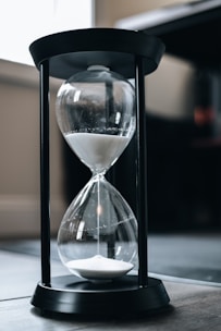 an hourglass sitting on top of a wooden table