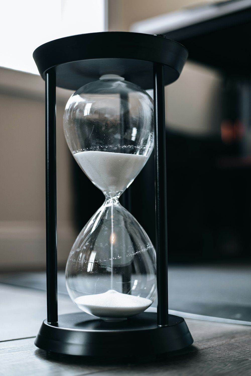 an hourglass sitting on top of a wooden table