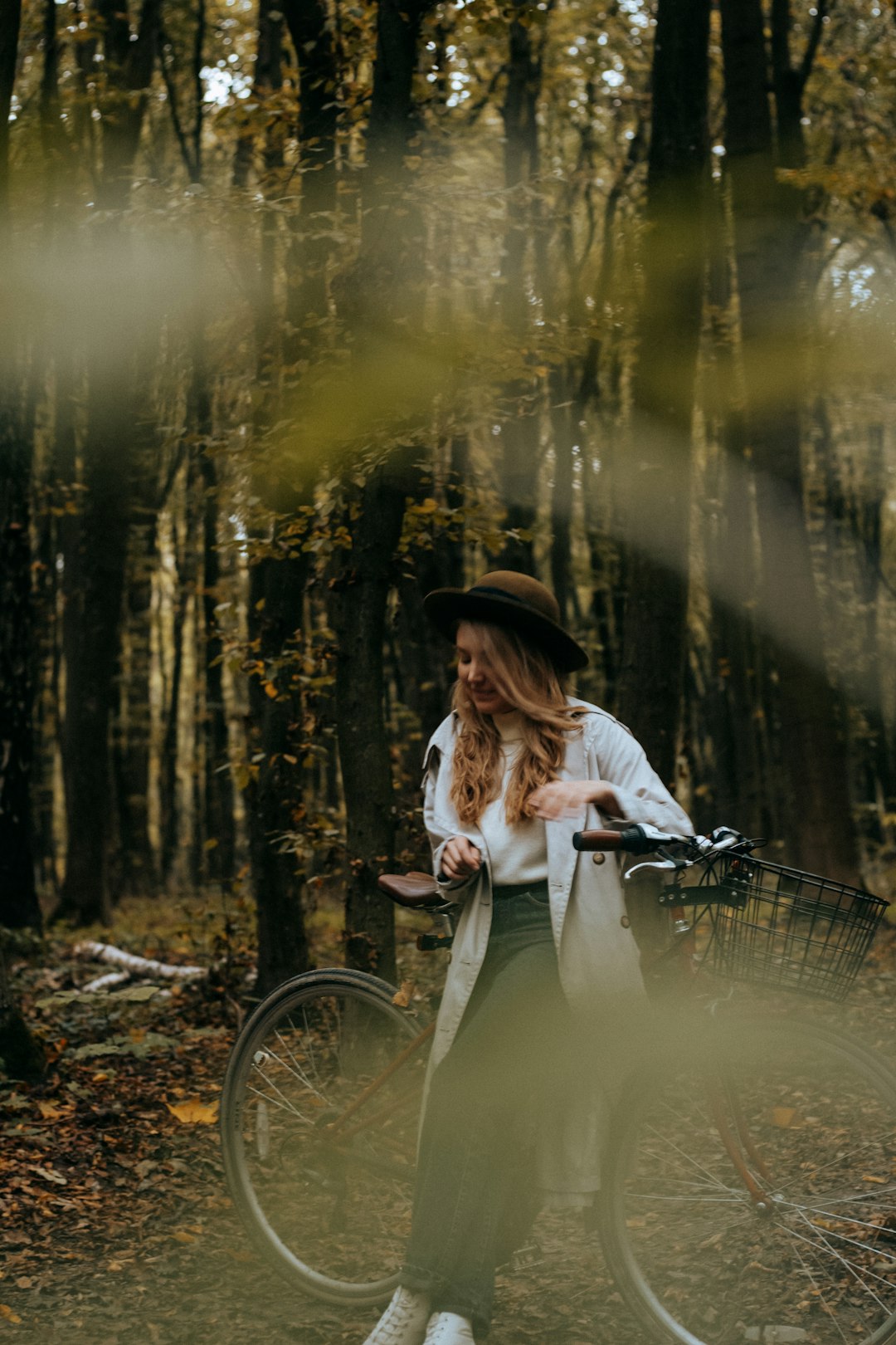 woman in white long sleeve shirt riding on bicycle
