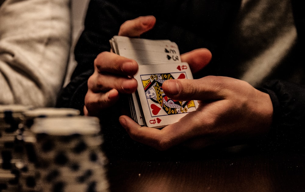 person holding king of spade playing card