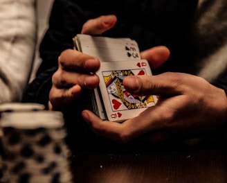 person holding king of spade playing card