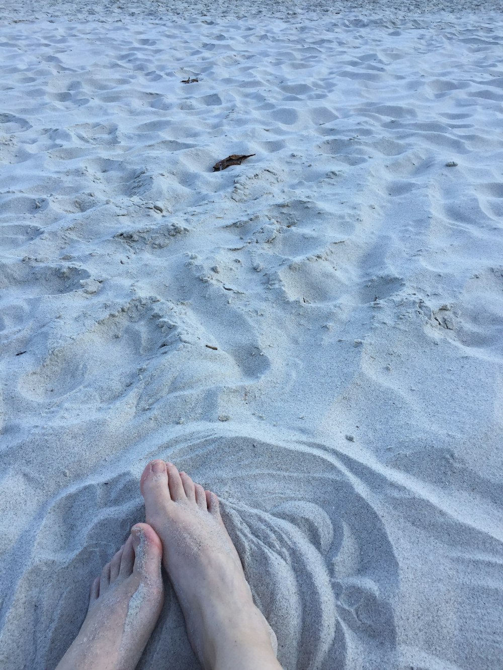 person standing on brown sand during daytime