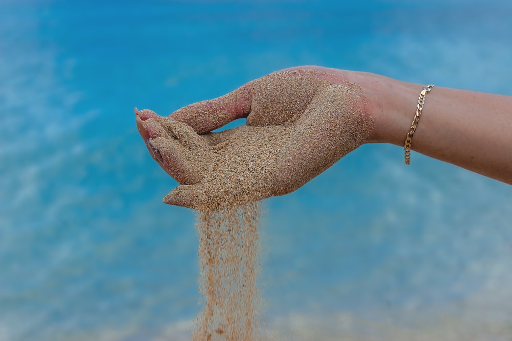 person in blue denim jeans and silver bracelet