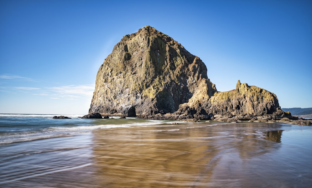 brown rock formation on sea shore during daytime