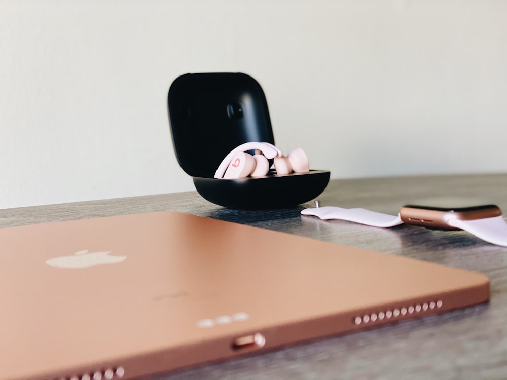 black iphone 4 on brown wooden table