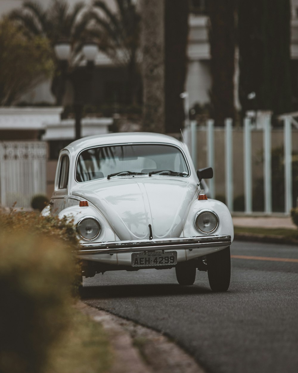 white classic car on road during daytime