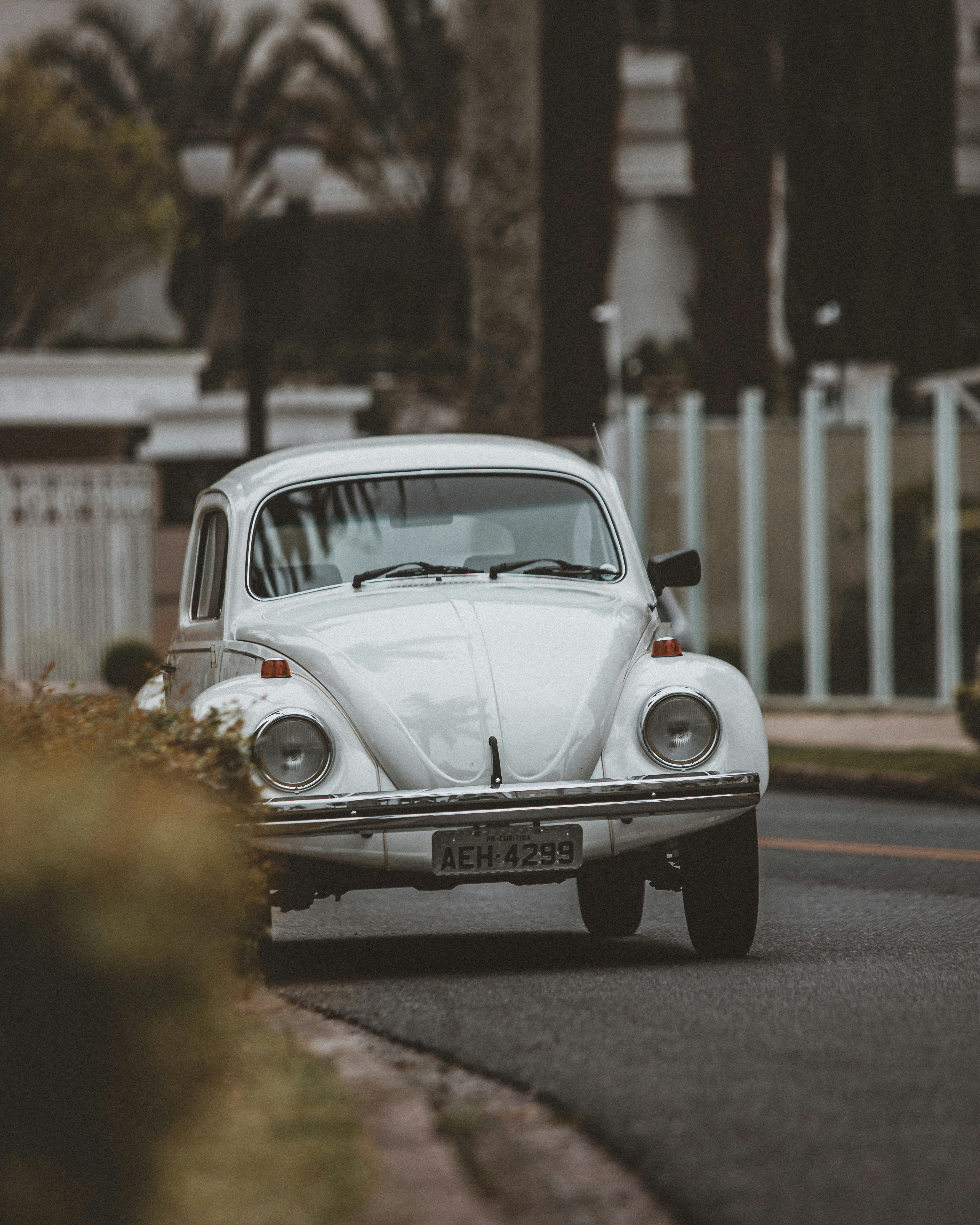 white classic car on road during daytime