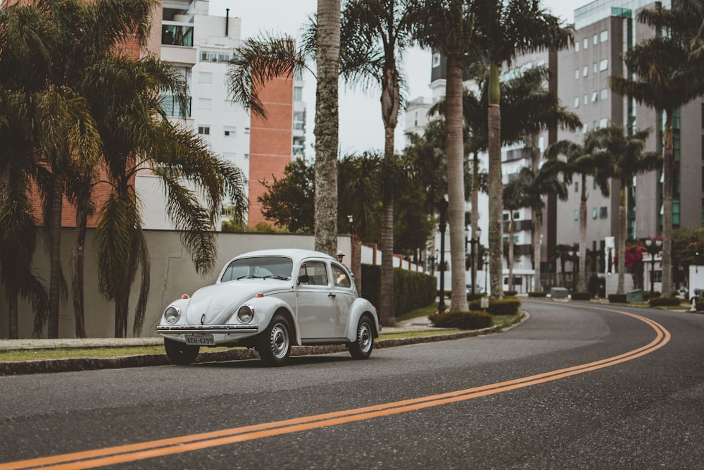 white coupe on road during daytime