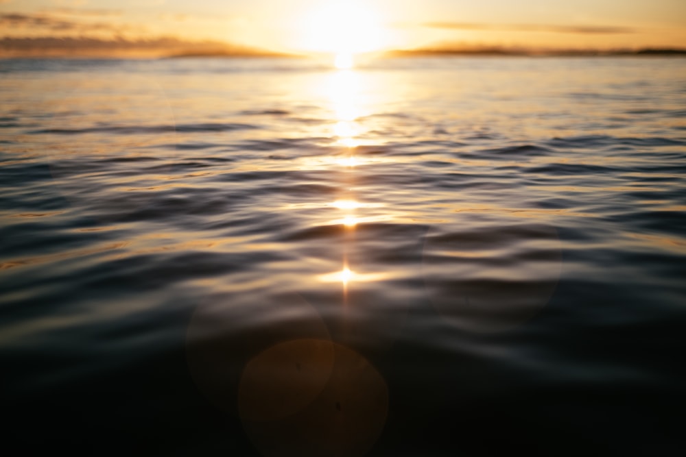 body of water during sunset