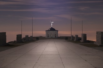 A serene view of Saint Thomas Mount at sunrise with pilgrims walking the path in quiet reflection.