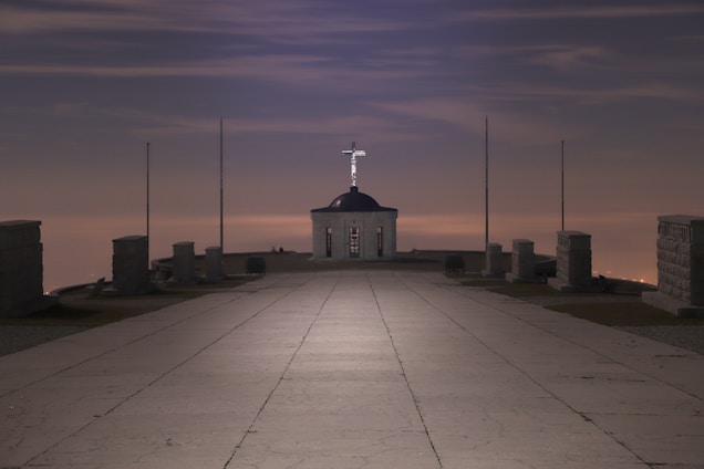 A serene view of Saint Thomas Mount at sunrise with pilgrims walking the path in quiet reflection.