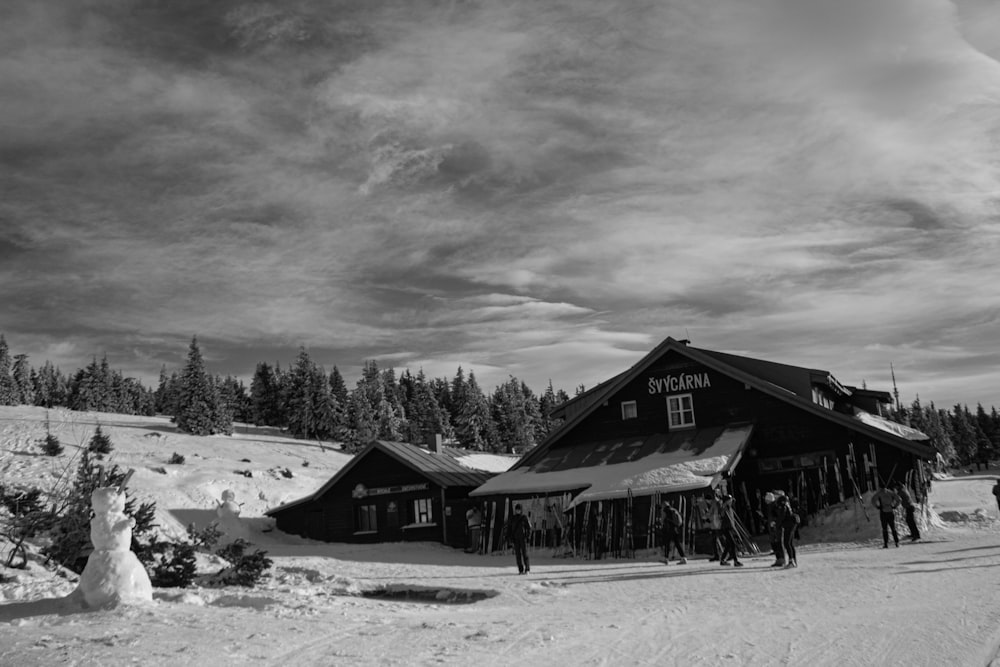 grayscale photo of house on snow covered ground