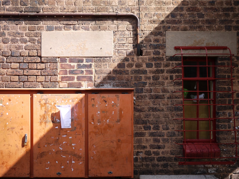 brown wooden door on brick wall