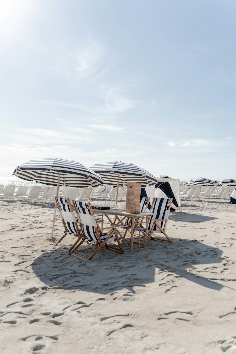 brown wooden chairs on beach during daytime