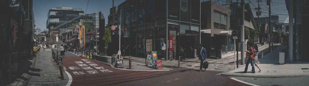 people walking on sidewalk near building during daytime