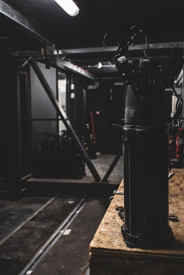 A vibrant backstage scene showing technicians preparing stage equipment for a live performance.