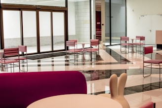 red chairs and table near glass window