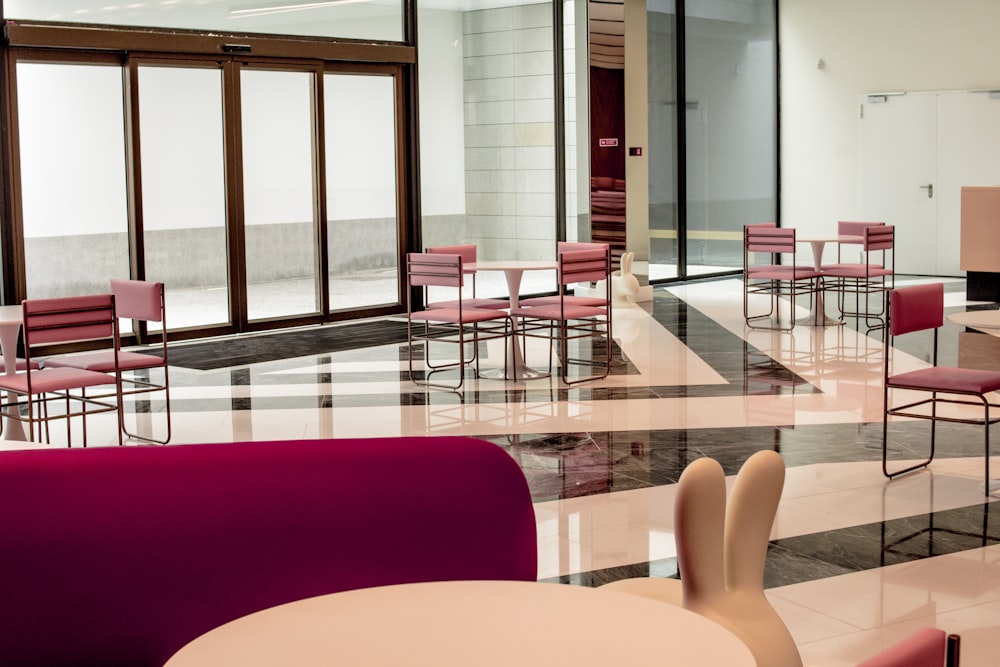 red chairs and table near glass window