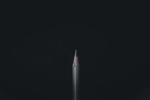 white and black pencil on black background