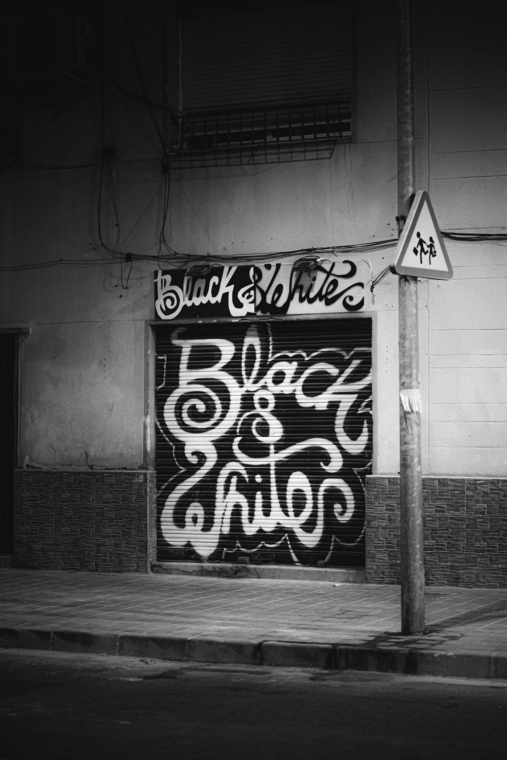 grayscale photo of black and white wall graffiti