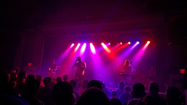 people watching band performing on stage