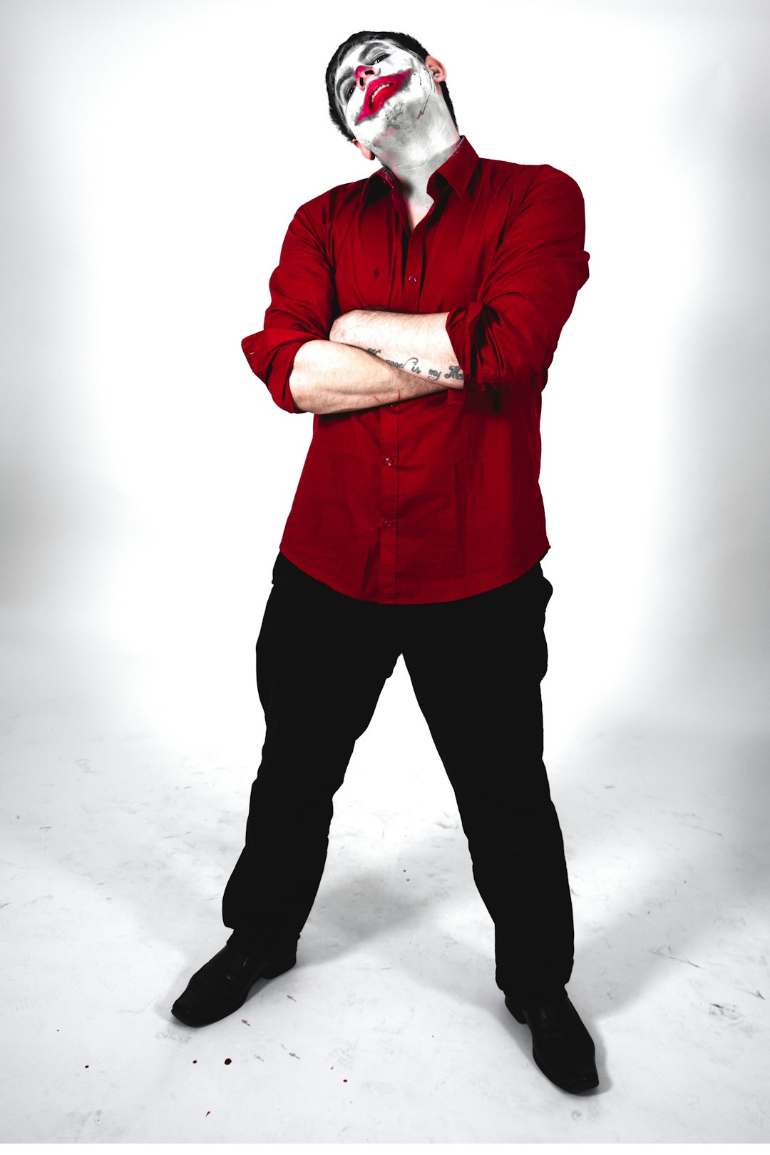 man in red dress shirt and black pants